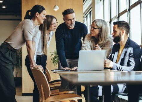 A group of employees discussing program A group of employees discussing program