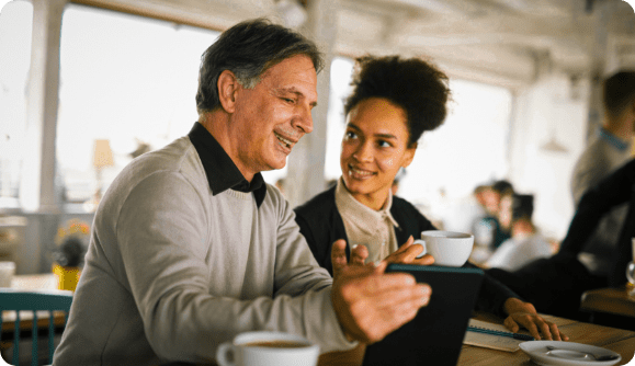 A joyful business Man and one of his employees having a working lunch.